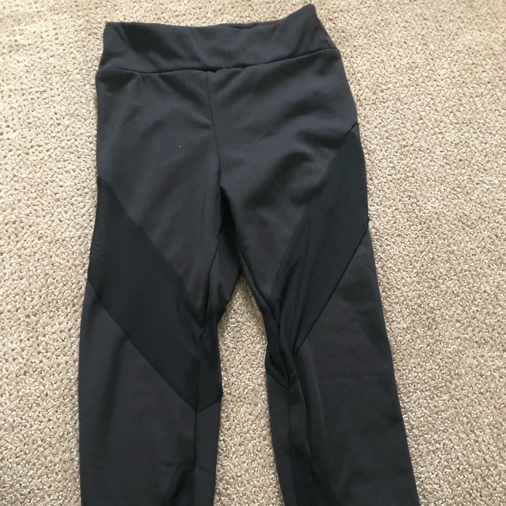 Black leggings with mesh cutouts.